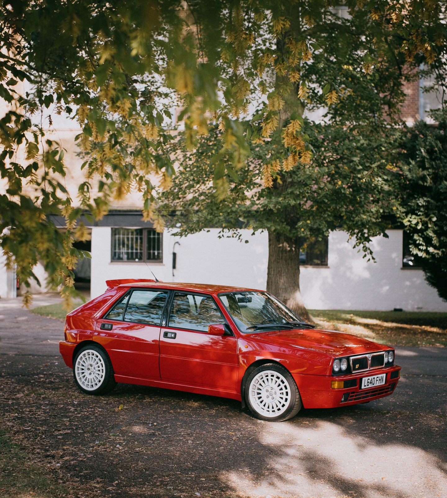 A close up of the front of a classic Yellow BMW, showing the badge in detail